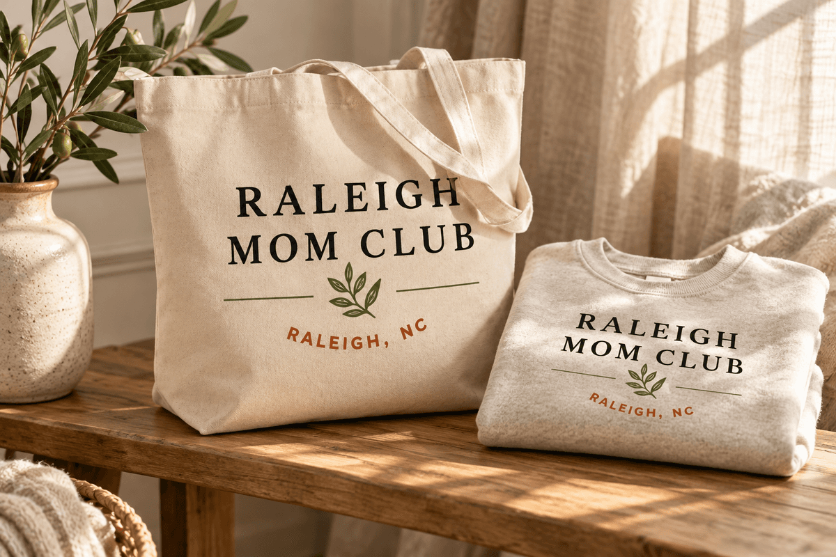Brand concept: a canvas tote and oatmeal sweatshirt featuring the Raleigh Mom Club logo